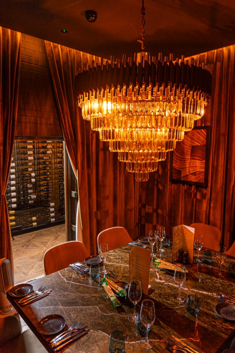 The vault dining room, chandelier and wine store beyond