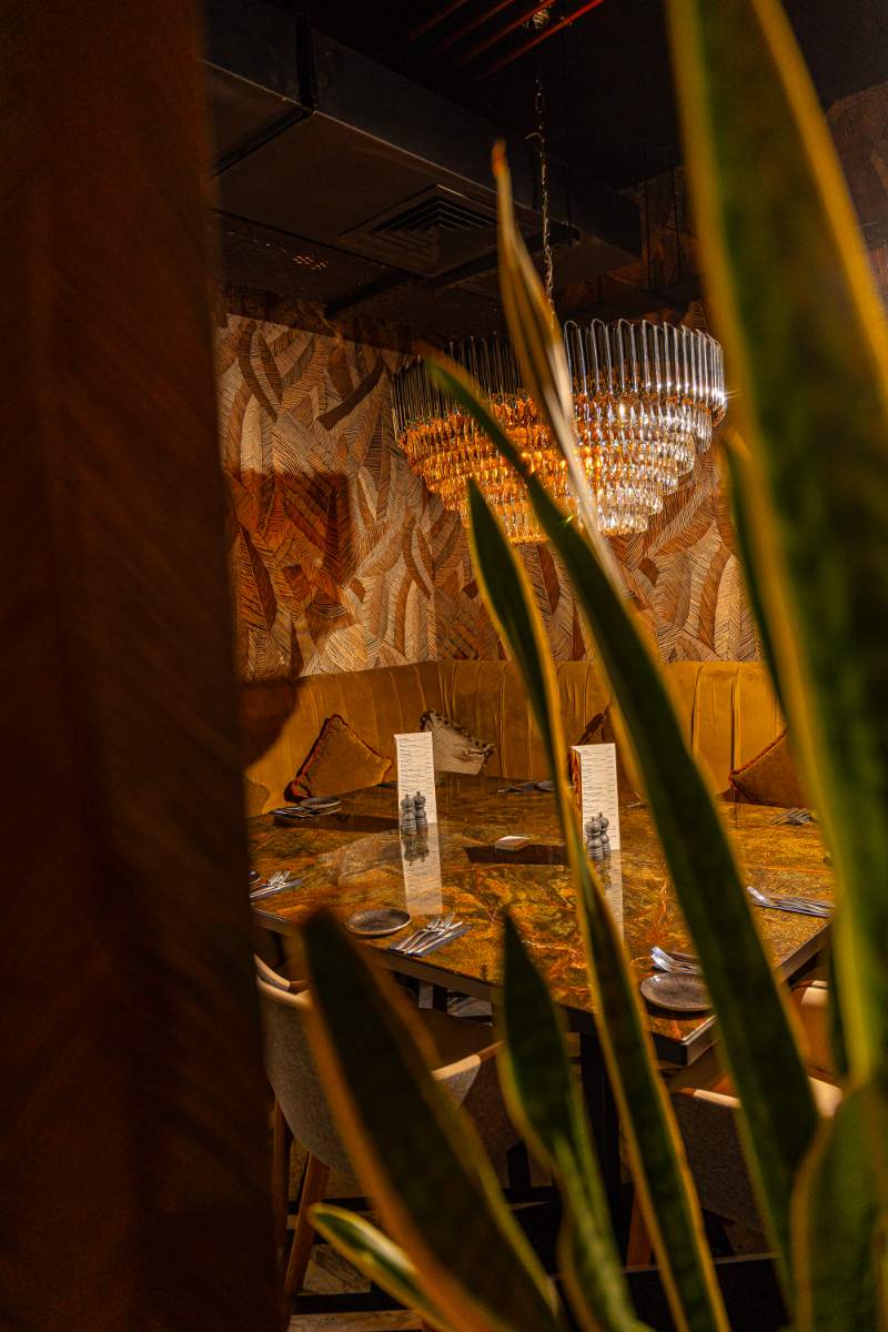 The VIP dining area, set beneath the amber chandelier